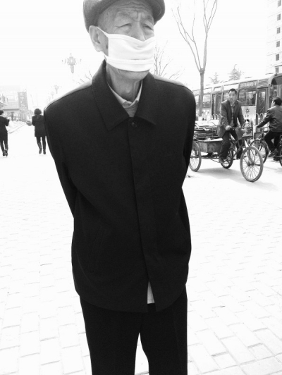 浮塵天里戴口罩的老人